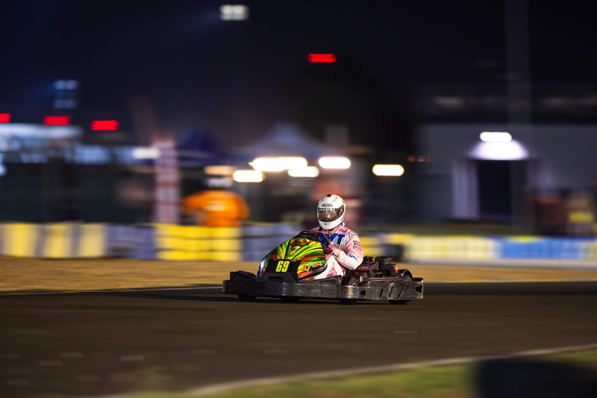 Single go-kart blurred in motion during a night race